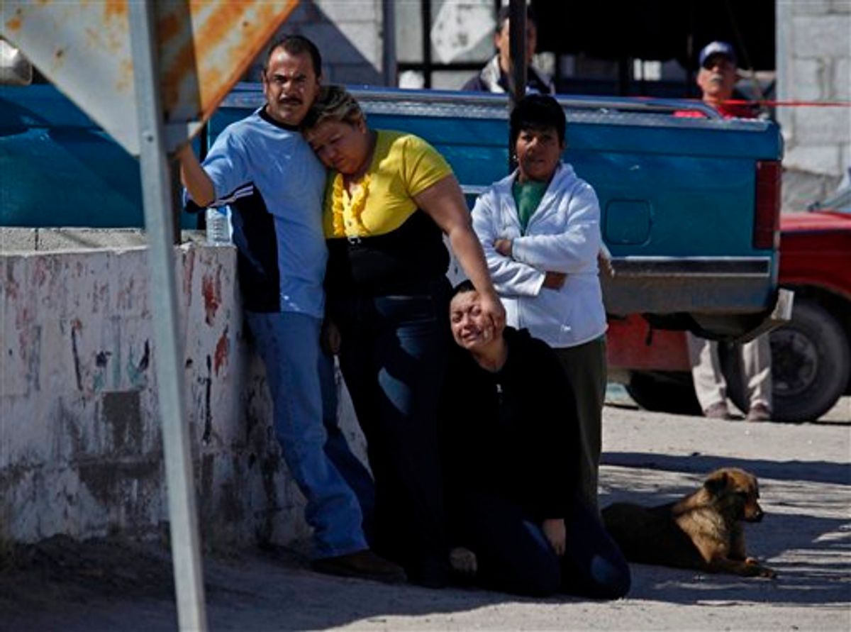 Family members of community leader Calisto Perez Mena react as they arrive near the place where he was killed in San Isidro, on the outskirts of Ciudad Juarez, Mexico. (AP Photo/Alexandre Meneghini)    