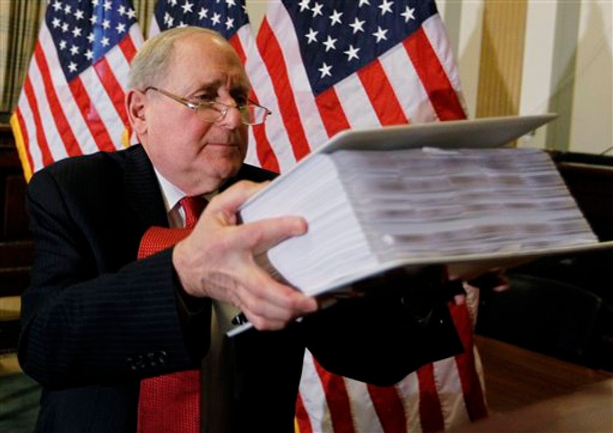 Senate Investigations subcommittee Chairman Sen. Carl Levin, D-Mich., lifts a binder of exhibit documents on the role of investment banks on the Wall Street financial crisis, as he briefs reporters on Capitol Hill in Washington, Monday, April 26, 2010, ahead of the Goldman Sachs hearings. (AP Photo/Charles Dharapak) (AP Photo/Charles Dharapak) (AP)