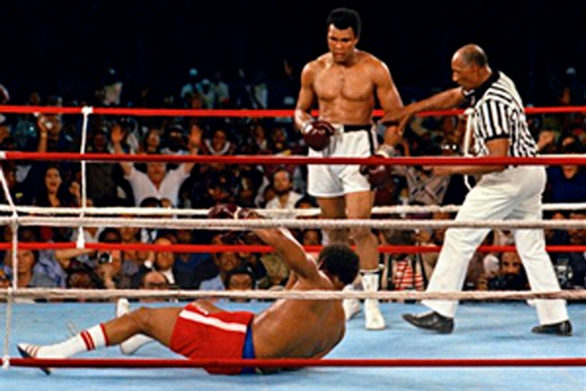 FILE - In this Oct. 30, 1974 file photo, referee Zack Clayton, right, steps in after challenger Muhammad Ali looks on after knocking down defending heavyweight champion George Foreman in the eighth round of their championship bout in Kinshasa, Zaire. Ali regained the world heavyweight crown by knockout in the eighth round of the fight dubbed "Rumble in the Jungle." (AP Photo/File) (Anonymous)