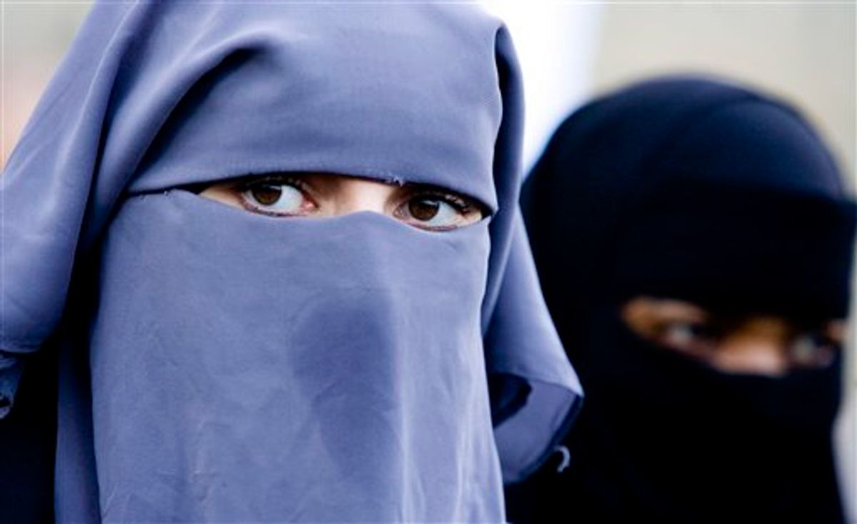 File - In this Nov. 30, 2006 file photo unidentified women are seen wearing a niqab in The Hague, Netherlands.  A parliamentary committee in Belgium on Wednesday March 31, 2010, has unanimously voted to ban the wearing of full face-covering veils in public, a major step in the country's legislative process. The full House of Representatives is now expected to vote on the issue late April. (AP Photo/ Fred Ernst, File) (AP)