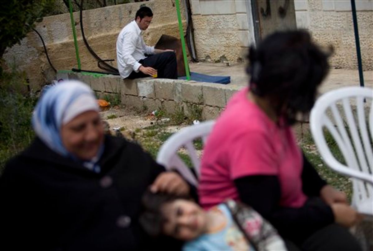 A Palestinian family sit outside a disputed house as Jewish settler rests at the house door, in the east Jerusalem neighborhood of Sheikh Jarrah, Thursday, March 25, 2010. Following a seemingly chilly reception at the White House, Benjamin Netanyahu is learning the hard way that he can't have it all. The Israeli leader will not likely be able to settle east Jerusalem with Jews and maintain strong relations with the Obama administration. He will be hard pressed to please his far-right coalition partners and still negotiate credibly with the Palestinians. (AP Photo/Bernat Armangue) (AP)