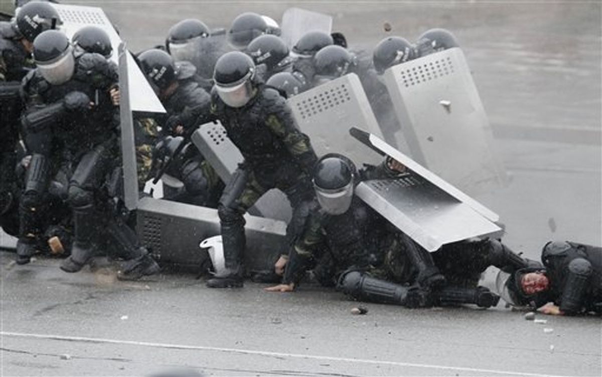 Kyrgyz riot police come under attack from demonstrators in Bishkek, Kyrgyzstan, Wednesday, April 7, 2010. Police in Kyrgyzstan opened fire on thousands of angry protesters who tried to seize the main government building amid rioting in the capital as protests spread across the Central Asian nation. (AP Photo/Ivan Sekretarev) (AP)