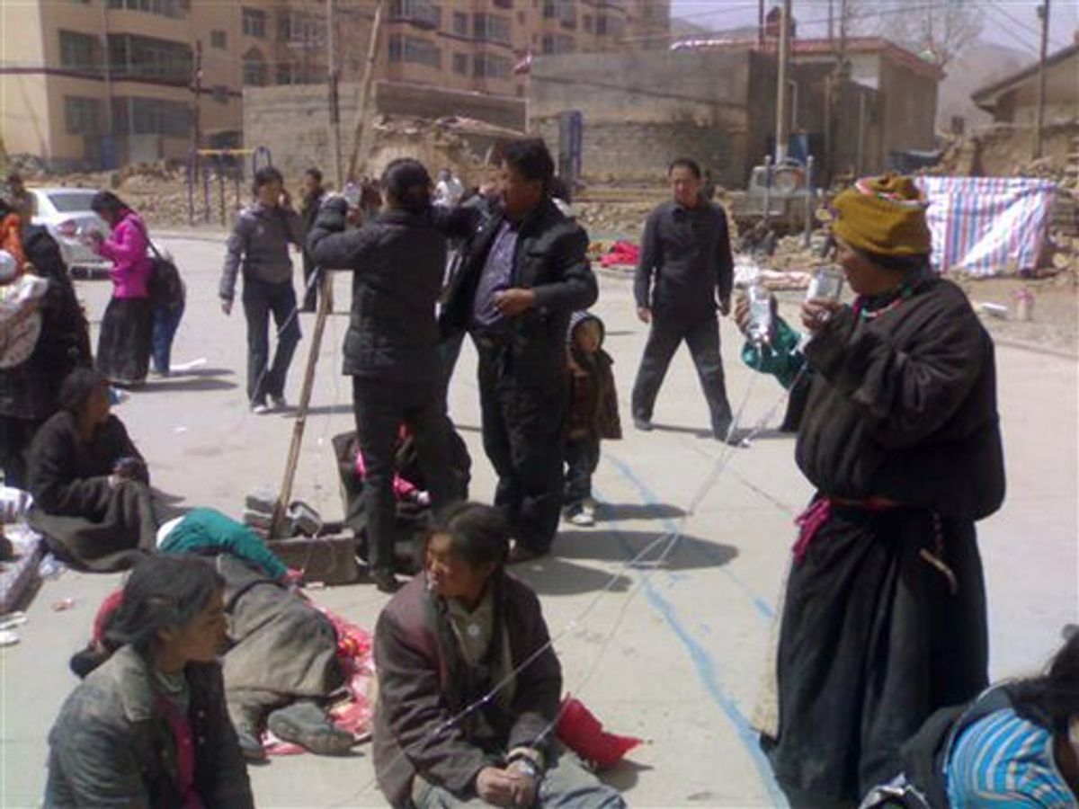 In this photo taken by a mobile phone, local people gather outside after being evacuated from buildings following an earthquake that hit the Tibetan Autonomous Prefecture of Yushu, northwest China's Qinghai province, Wednesday, April 14, 2010. A series of strong earthquakes struck China's western Qinghai province Wednesday, toppling houses, killing scores of people and burying many others in a mountainous rural area, officials and state media said. (AP Photo/Xinhua, Zhang Hongshuan)  NO SALES (AP)