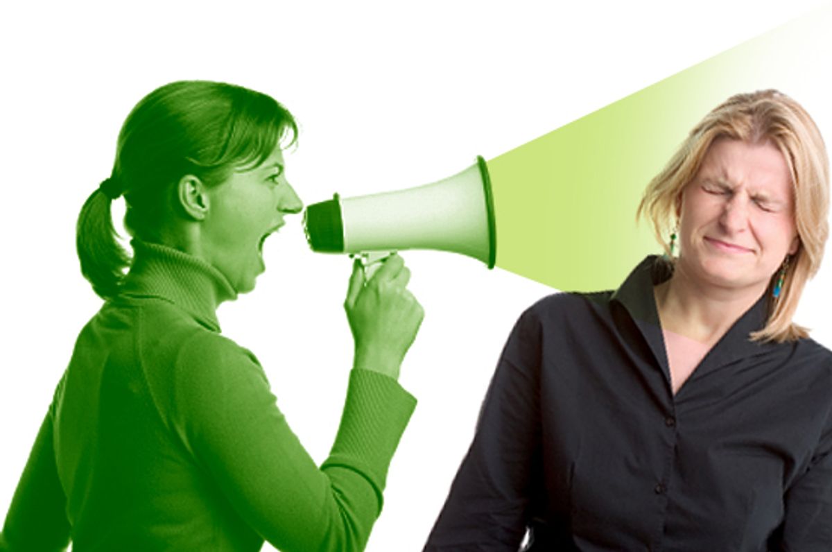 Young woman shouting at another woman through a megaphone  (Mateusz Zagorski)
