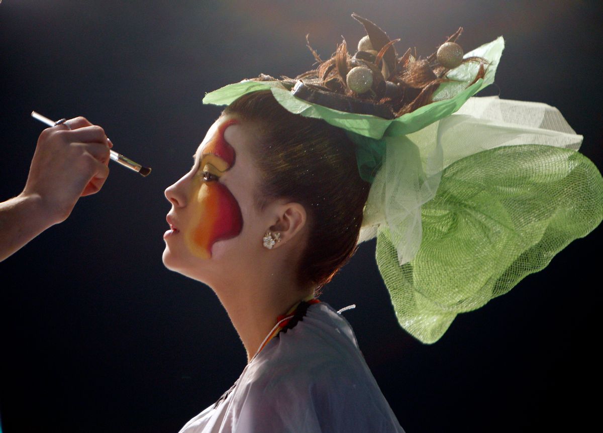 A stylist puts make-up on a model during the Crystal Angel Festival in Kiev April 14, 2010. The annual international competition of hairdressers, fashion and design started in the Ukrainian capital today. REUTERS/Gleb Garanich (UKRAINE - Tags: FASHION SOCIETY) (Reuters)