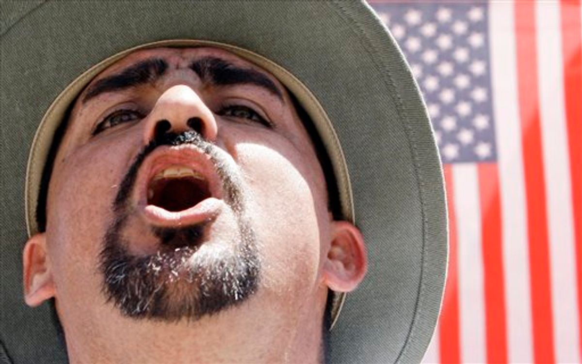 A protester shouts as he joins thousands attending an immigration rally in Arizona on April, 25, 2010.       (AP Photo/Ross D. Franklin)