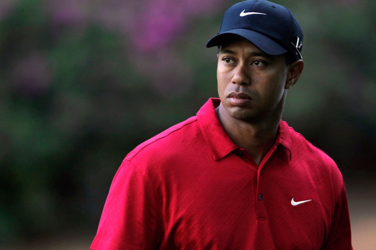 Tiger Woods walks off the 13th green during 2010 Masters on Sunday.