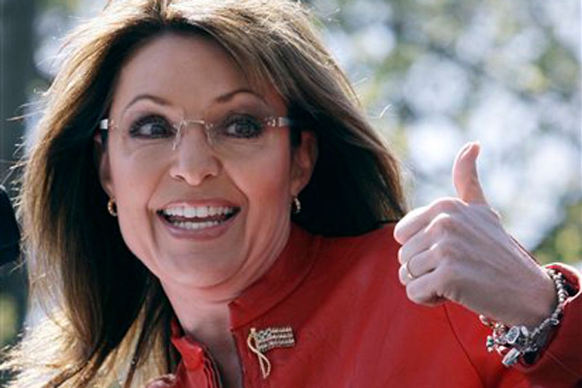 FILE - In this April 14, 2010  file photo, Sarah Palin flashes a thumbs up towards her husband Todd as she begins to address a crowd during a stop of the Tea Party Express on Boston Common in Boston. Sarah Palin could have hardly picked a more liberal town than Eugene to give a speech. The university town has been a hotbed of radical activity over the years, from the Vietnam War to environmental activism. But Palin is the headliner at a Republican Party fundraiser Friday night. (AP Photo/Charles Krupa, File)  (Charles Krupa)
