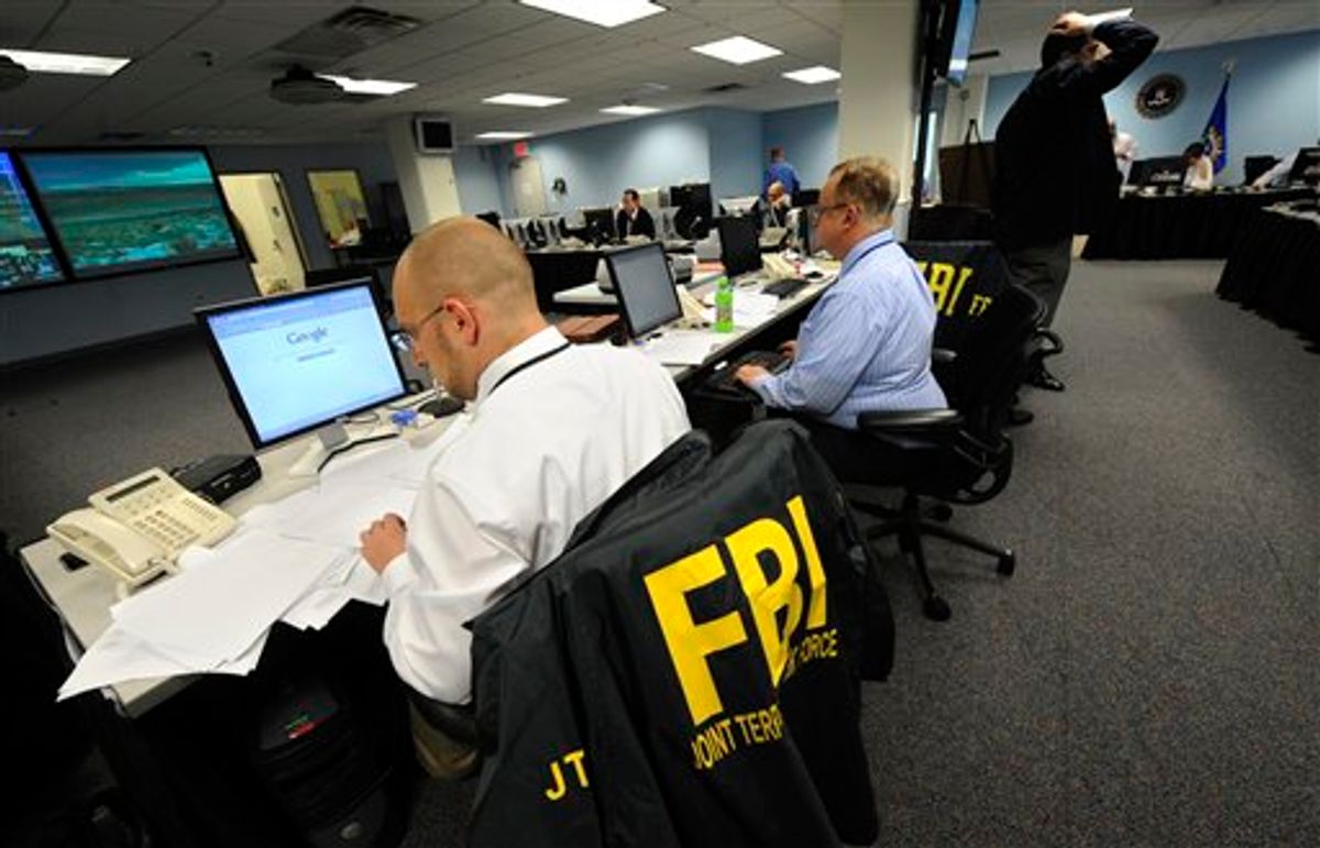 Agents from the FBI and other law enforcement agencies work at a 24-hour operations center at FBI headquarters, Monday, May 3, 2010, in the Chelsea section of New York. The center was set up to coordinate the investigation of the Times Square incident involving a vehicle loaded with explosive material. (AP Photo/ Louis Lanzano) (AP)