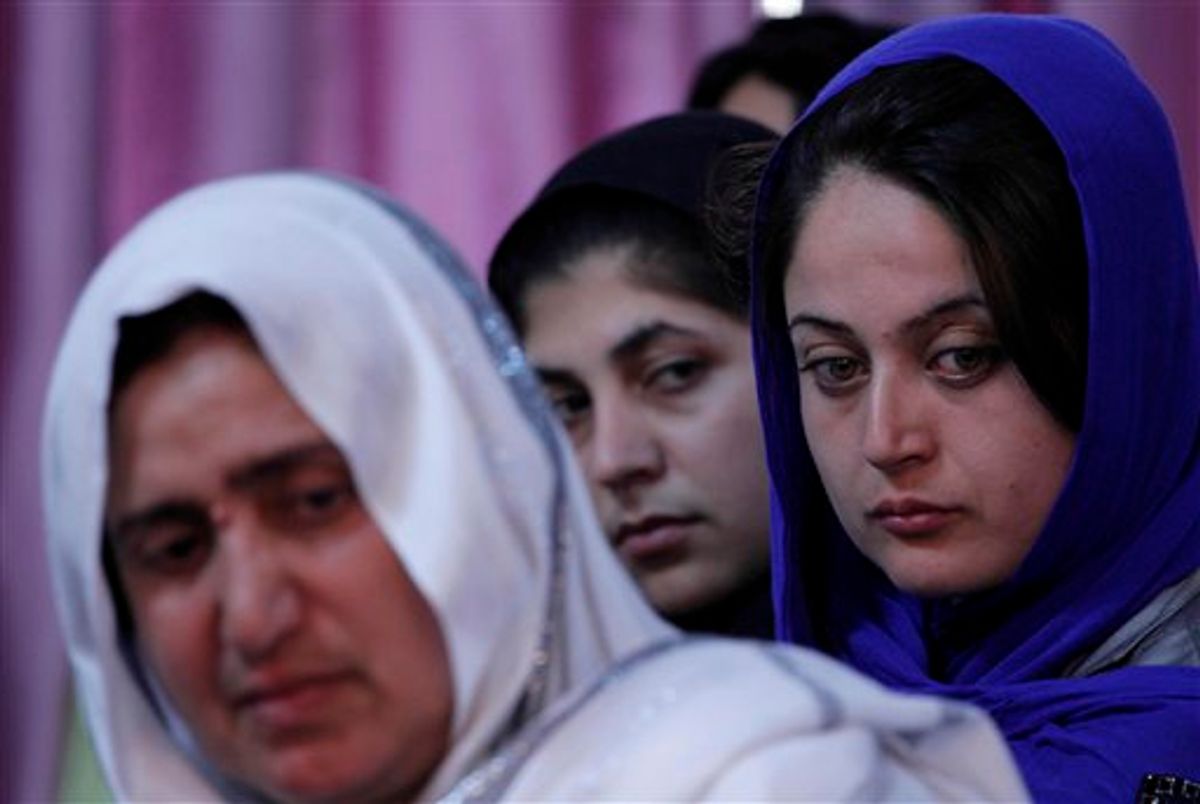 Afghan women, victims of war, look on during a "victims' jirga"  (a meeting) in Kabul. Afghanistan, Sunday, May 9, 2010. Mothers of slain teenage sons, men marred by mine blasts and tearful widows were among Afghans who spoke out Sunday at a conference billed as the first major gathering of victims of decades of war in their country. (AP Photo/Dar Yasin) (AP)