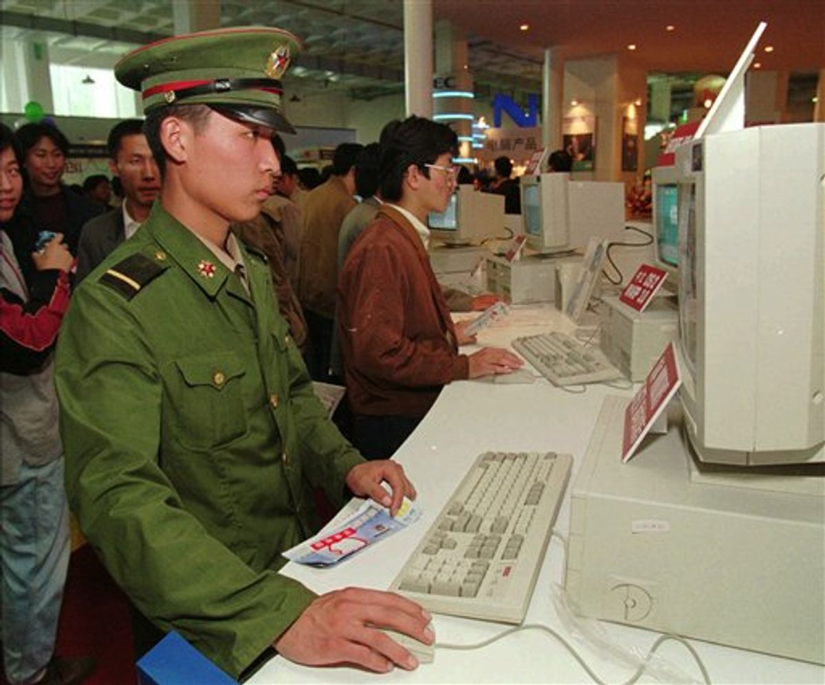 FILE - In this Oct. 10, 1995 file photo, a Chinese soldier tries out a desktop computer at a computer exhibition in Beijing. Rigid restrictions on Internet usage imposed this month on the 2.3-million strong Chinese armed services are sure to cramp the already lackluster social lives of the predominantly young, male force. Online dating was given the boot, along with blogs, personal websites and visits to Internet cafes. (AP Photo/Mike Fiala, File) (AP)