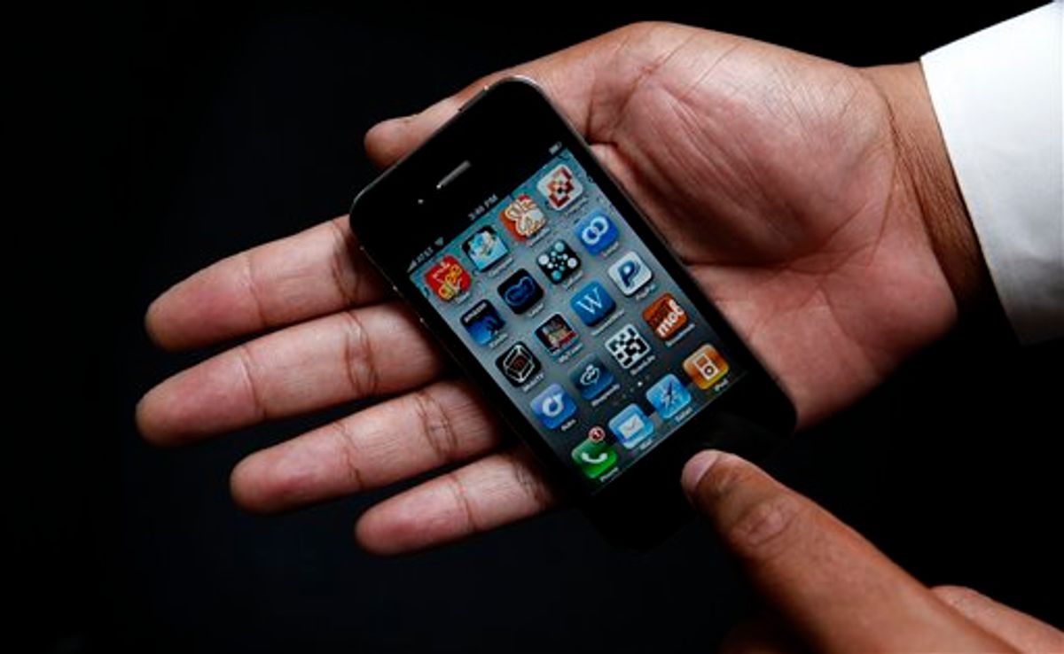 An Associated Press reporter holds the new Apple iPhone during a product test review in San Francisco, Thursday, June 24, 2010. (AP Photo/Jeff Chiu) (AP)