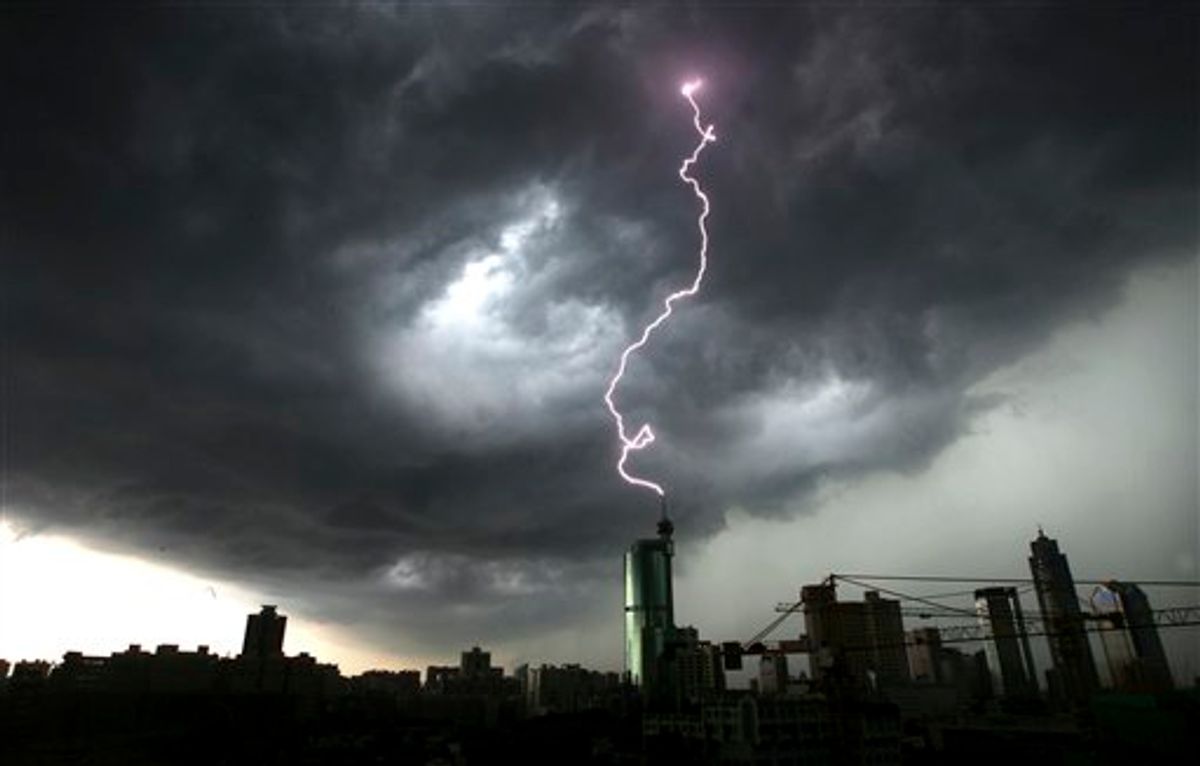 In this photo taken Monday, June 21, 2010, a lightning strikes the top of a building in Foshan in south China's Guangdong province. On Tuesday, President Hu Jintao and Premier Wen Jiabao have called for stepped-up rescue efforts after torrential rains brought down a dike in southern China, forcing 68,000 people to flee their homes. (AP Photo) ** CHINA OUT ** (AP)
