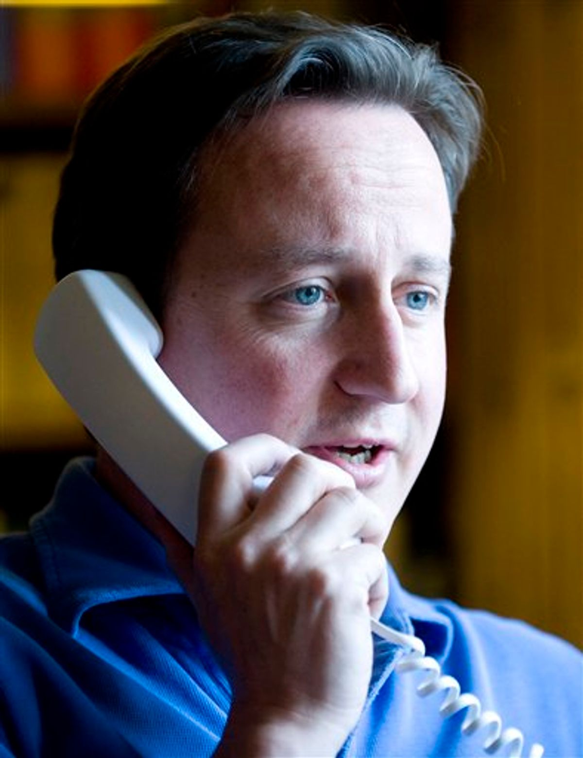 British Prime Minister David Cameron talks to President Obama on the phone in his office at Chequers, England,  about the BP situation in the Gulf of Mexico, Saturday June 12, 2010. The leaking oil that has tainted the Gulf of Mexico is also threatening the political shores on both sides of the Atlantic, with a British company the villain.  (AP Photo / Andrew Parsons , PA ) ** UNITED KINGDOM OUT NO SALES NO ARCHIVE  ** (AP)
