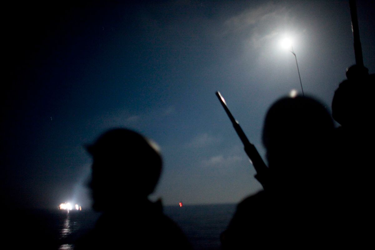 The view from aboard an Israeli naval vessel, as Israeli navy soldiers intercept several boats headed toward the Gaza Strip, while in international waters, early Monday.