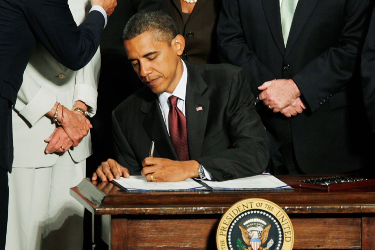 President Obama signs the Dodd-Frank Wall Street Reform and Consumer Protection financial reform bill in Washington on Wednesday.