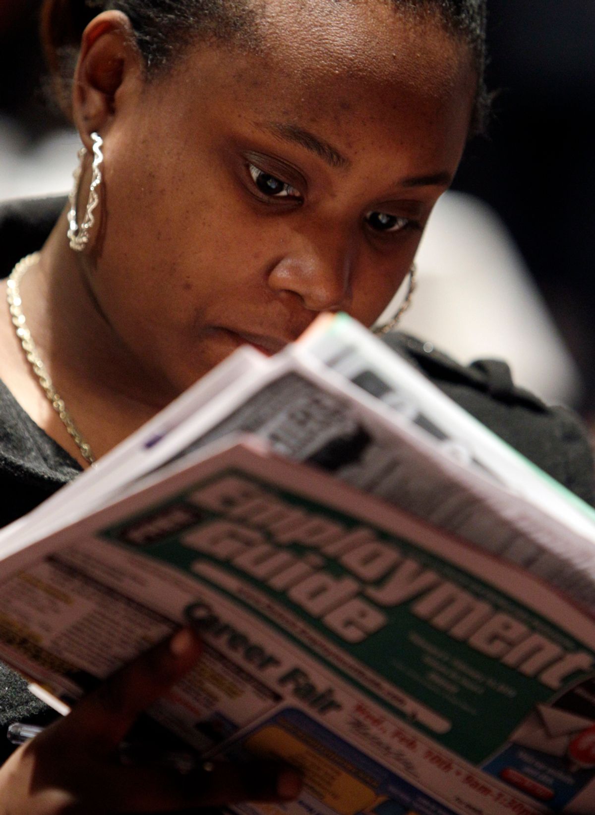 Santilya Bailey, of Detroit, looks for employment while attending a job fair in Detroit Wednesday, Feb. 10, 2010. The number of newly laid-off workers seeking unemployment benefits fell sharply last week, a hopeful sign the job market may be improving.(AP Photo/Paul Sancya)   (Paul Sancya)