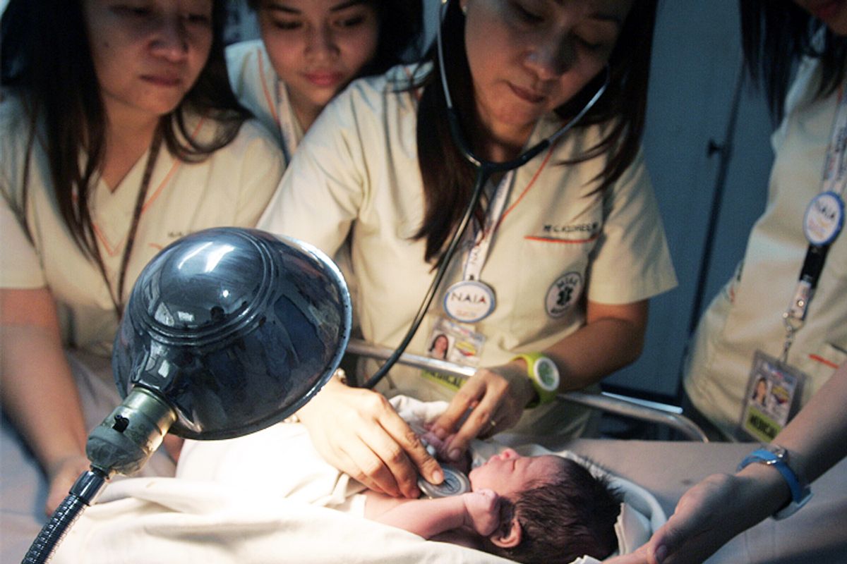 Nurses check the heartbeat of a newborn baby found inside the lavatory of an airplane at Manila's Ninoy Aquino International Airport.