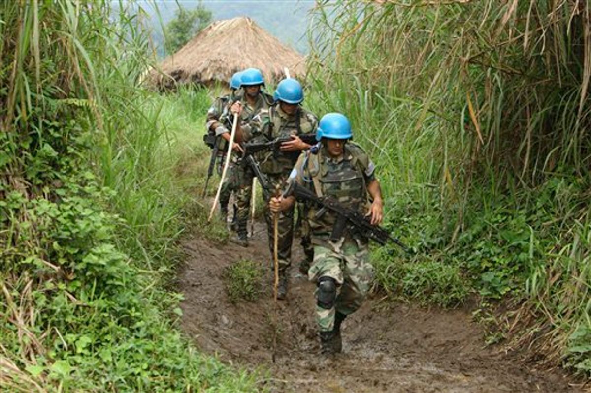 United Nations peacekeepers patrol near their encampment in the village of Kimua, deep in the heart of territory controlled by Rwandan Hutu rebels, in eastern Congo.   (AP/Rebecca Blackwell)