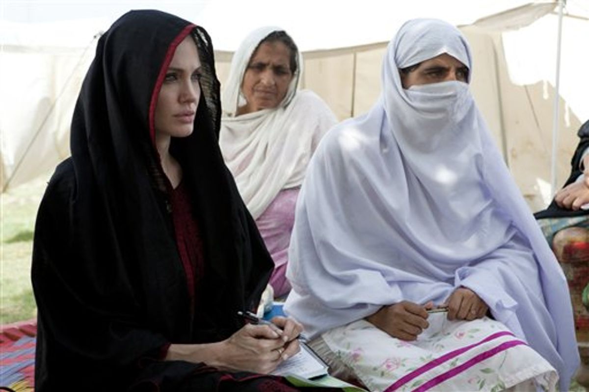 In this photo provided by the United Nations High Commission for Refugees, Angelina Jolie, left, the goodwill ambassador of UNHCR, sits with Pakistani flood-affected women during her visit to a camp for people displaced by heavy floods in Nowshera, Pakistan, Tuesday, Sept. 7, 2010. (AP Photo/United Nations High Commission for Refugees, J. Tanner) ** NO SALES, NO ARCHIVE, EDITORIAL USE ONLY **  (AP)