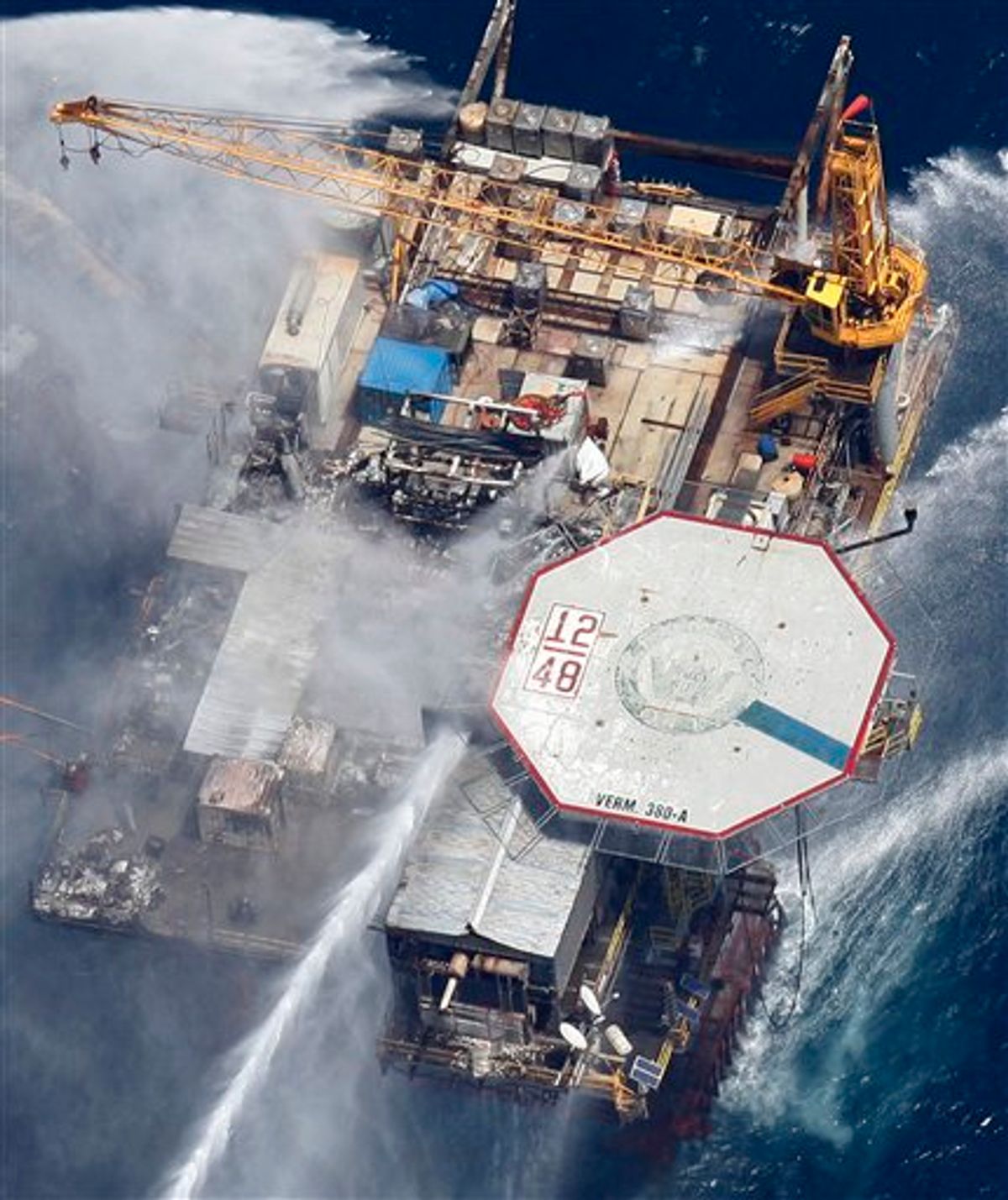 Boats are seen spraying water on an oil and gas platform that exploded in the Gulf of Mexico, of the coast of Louisiana., Thursday, Sept. 2, 2010. All 13 crew members were rescued.  (AP Photo/Gerald Herbert) (AP)