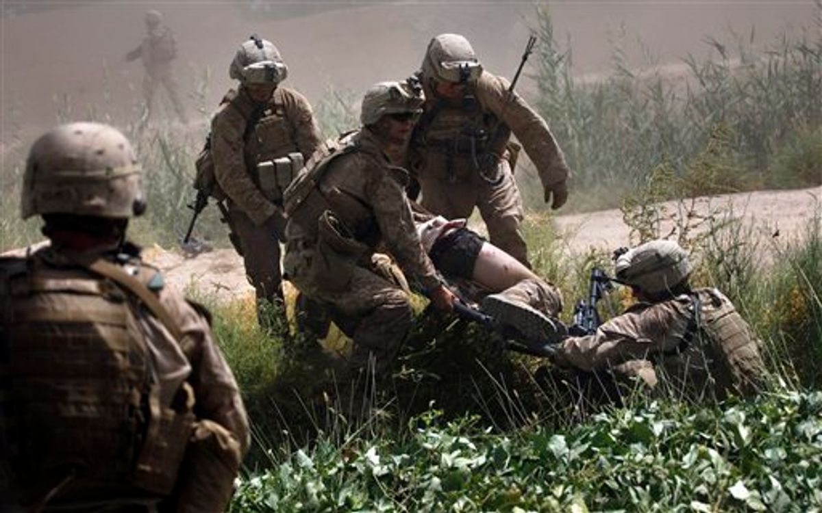 U.S. Marines prepare to carry one of two comrades wounded in an IED attack to a waiting U.S. Army Task Force Shadow medevac helicopter on a rescue mission west of Lashkar Gah, in southern Afghanistan, Saturday, Sept. 4, 2010. Aeromedical teams with the 101st Airborne's Task Force Destiny provide the fast medical evacuation of those wounded throughout southern Afghanistan. (AP Photo/Brennan Linsley) (AP)