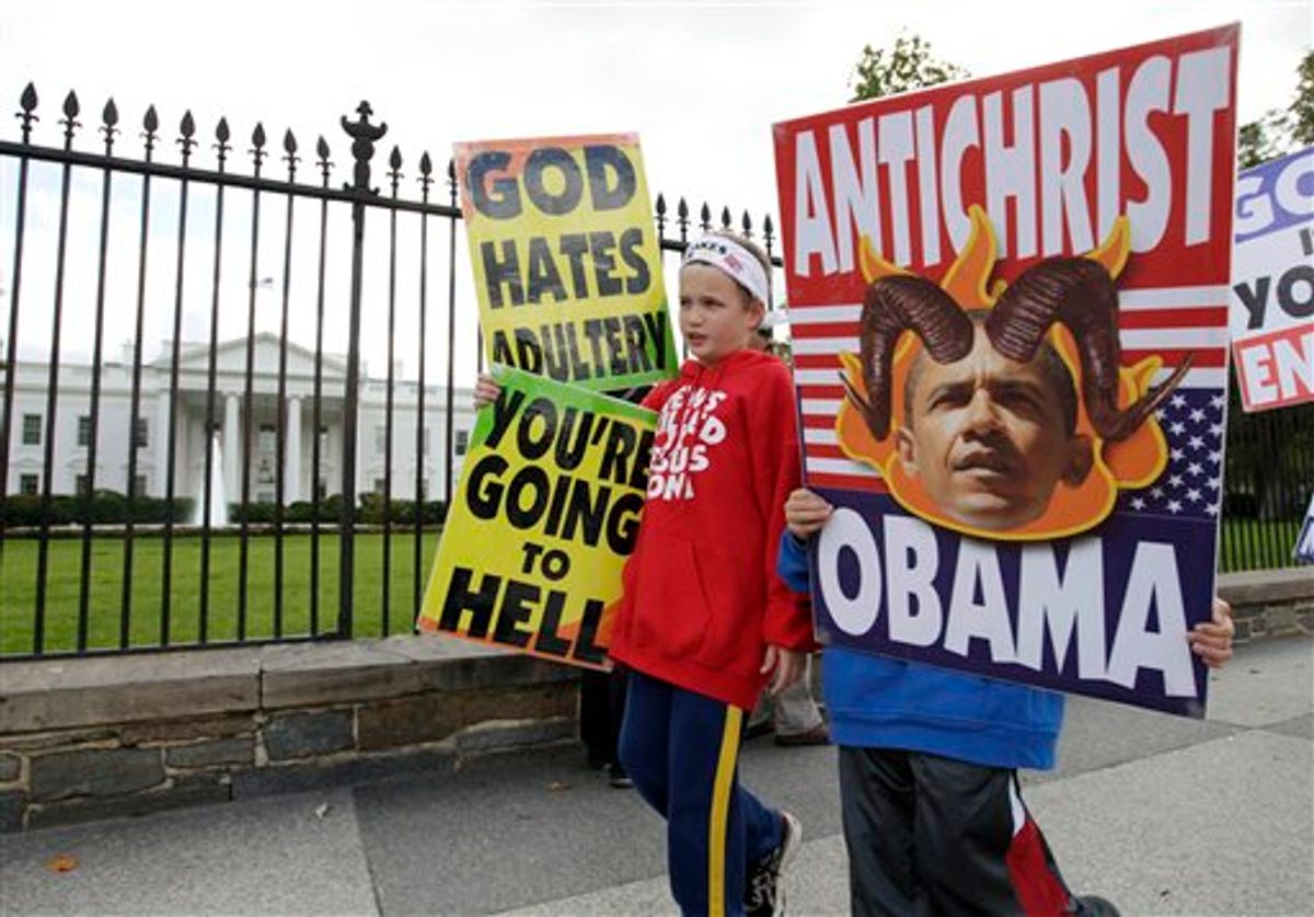Members of the Westboro Baptist Church, Luke Phelps-Roper, 8, left, and Seth Phelps, 9, both from Topeka, Kansas, picket outside the White House in Washington, Tuesday, Oct. 5, 2010. (AP Photo/Carolyn Kaster)  (AP)