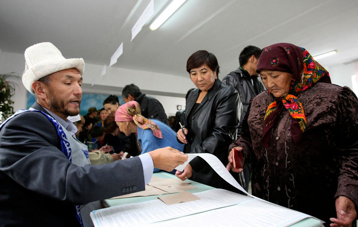 A woman receives ballot papers at a polling station during parliamentary elections in the village of Koy-Tash, some 15 km (9 miles) south-east from Bishkek, October 10, 2010. Kyrgyz voters cast their ballots on Sunday to create the first parliamentary democracy in Central Asia, in an election many hope can unite the country only four months after the worst bloodshed in its modern history.  REUTERS/Vladimir Pirogov  (KYRGYZSTAN - Tags: POLITICS ELECTIONS) (Â© Vladimir Pirogov / Reuters)