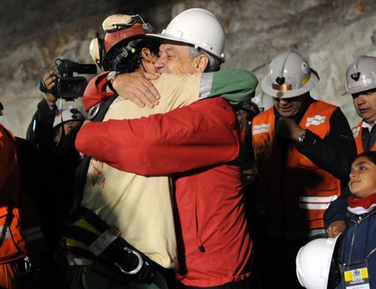 In this photo released by the Chilean presidential press office, Chile's President Sebastian Pinera, front right, hugs rescued miner Florencio Avalos after Avalos was rescued from the the collapsed San Jose gold and copper mine where he was trapped with 32 other miners for over two months near Copiapo, Chile, Tuesday Oct. 12, 2010.  (AP Photo/Jose Manuel de la Maza, Chilean presidential press office) (AP)