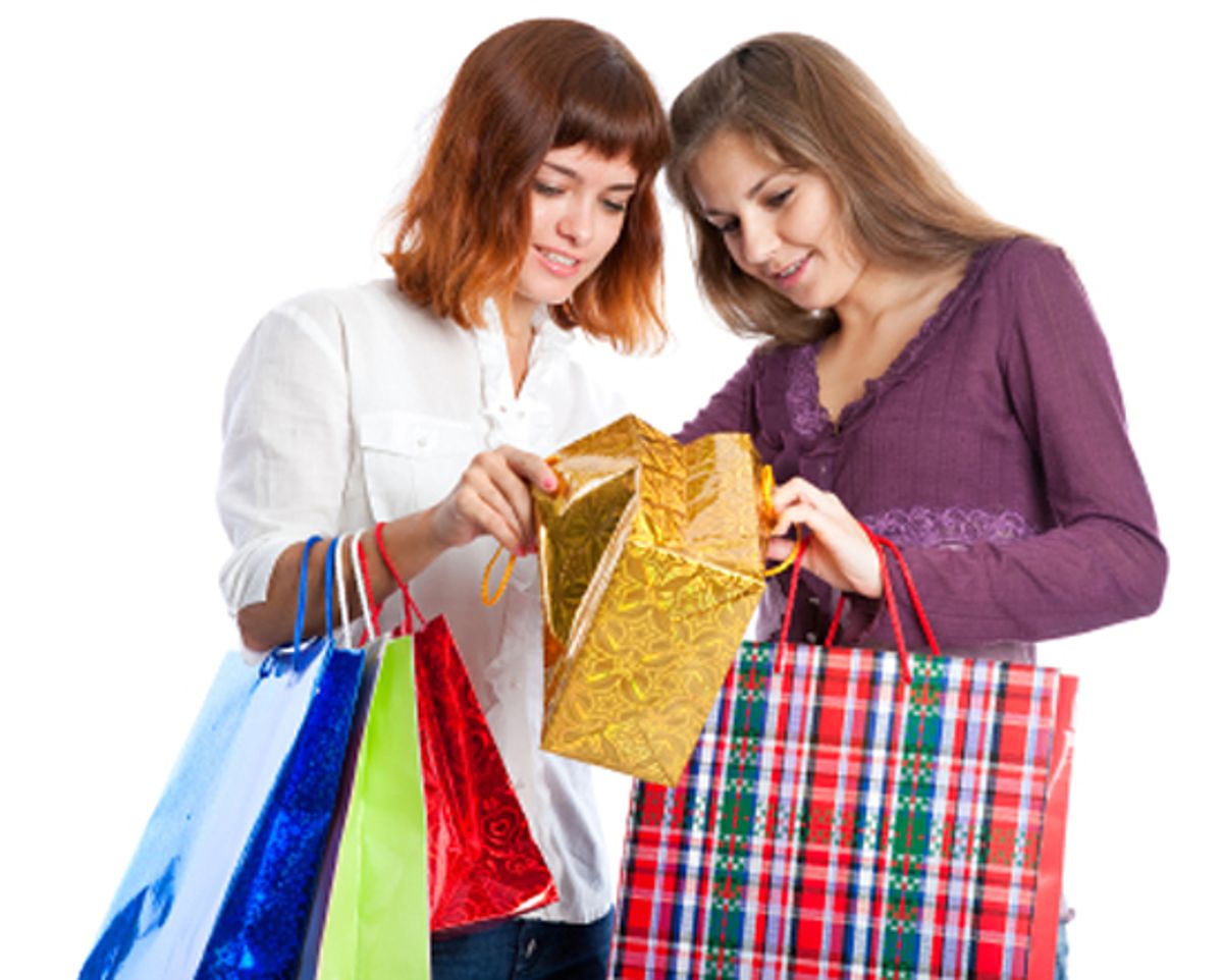 Two teen girls with bags look in the gold bag. Isolated on white background