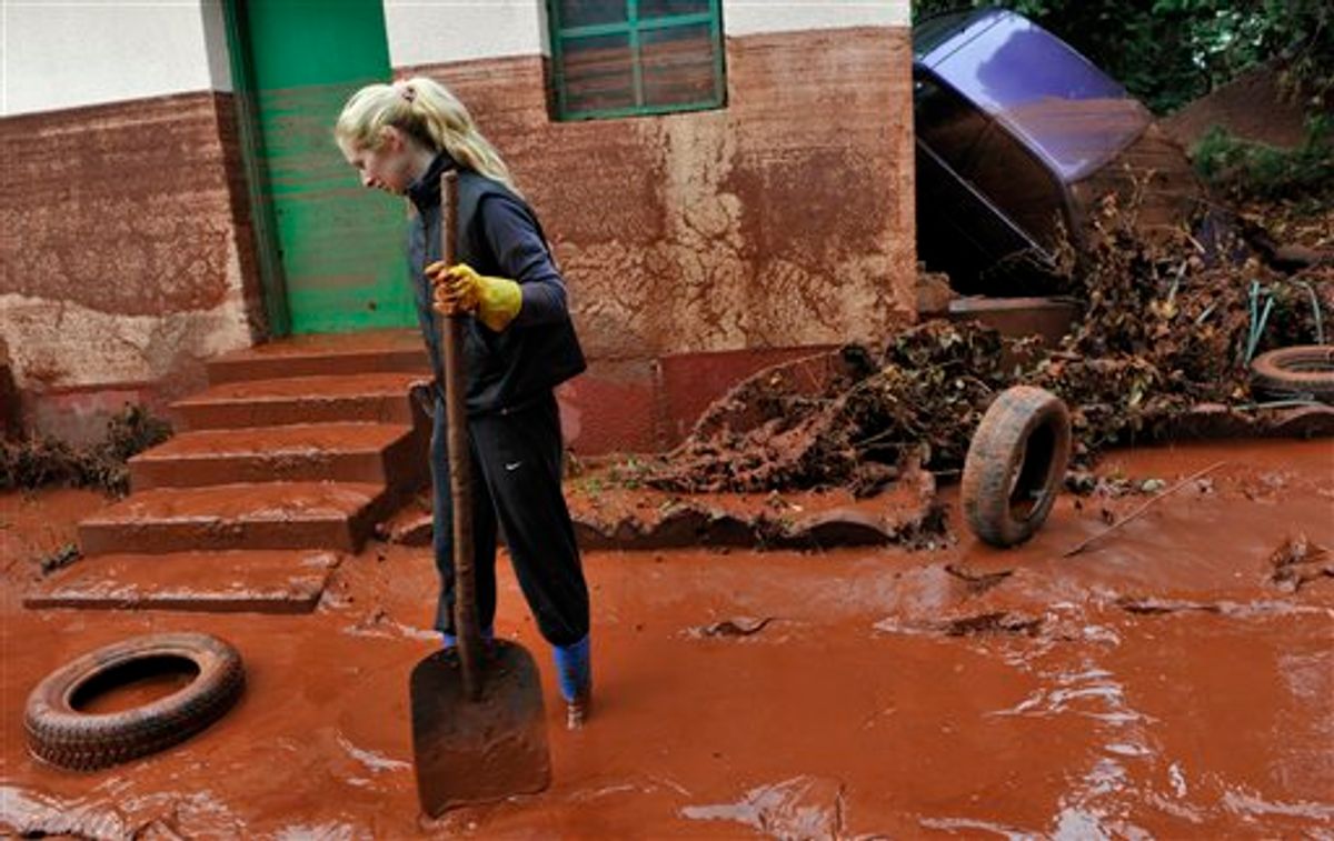 Tunde Erdelyi is seen in her yard flooded by toxic mud in the town of Devecser, Hungary, Tuesday, Oct. 5, 2010. Monday's flooding was caused by the rupture of a red sludge reservoir at an alumina plant in western Hungary and has affected seven towns near the Ajkai Timfoldgyar plant in the town of Ajka, 100 miles (160 kilometers) southwest of Budapest. (AP Photo/Bela Szandelszky) (AP)