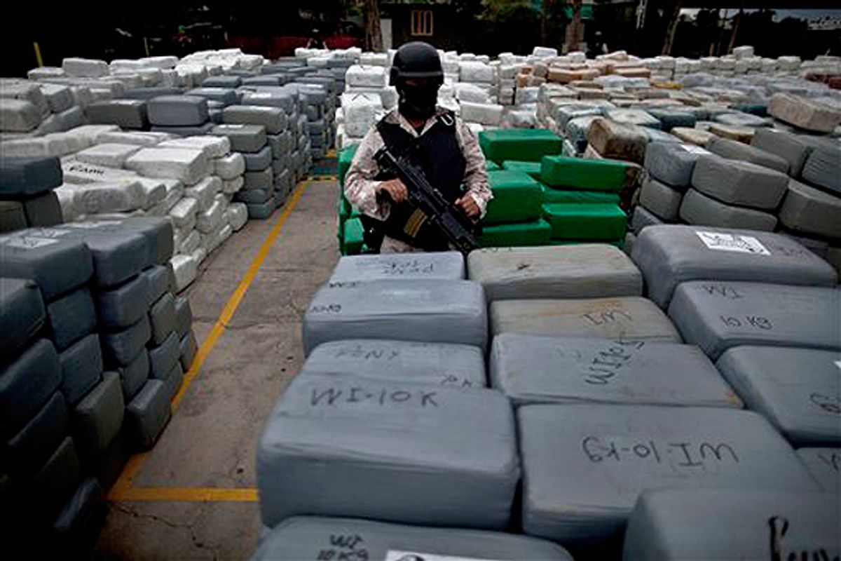  A soldier guards packages of confiscated marijuana in Tijuana, MX in 2010. (AP)