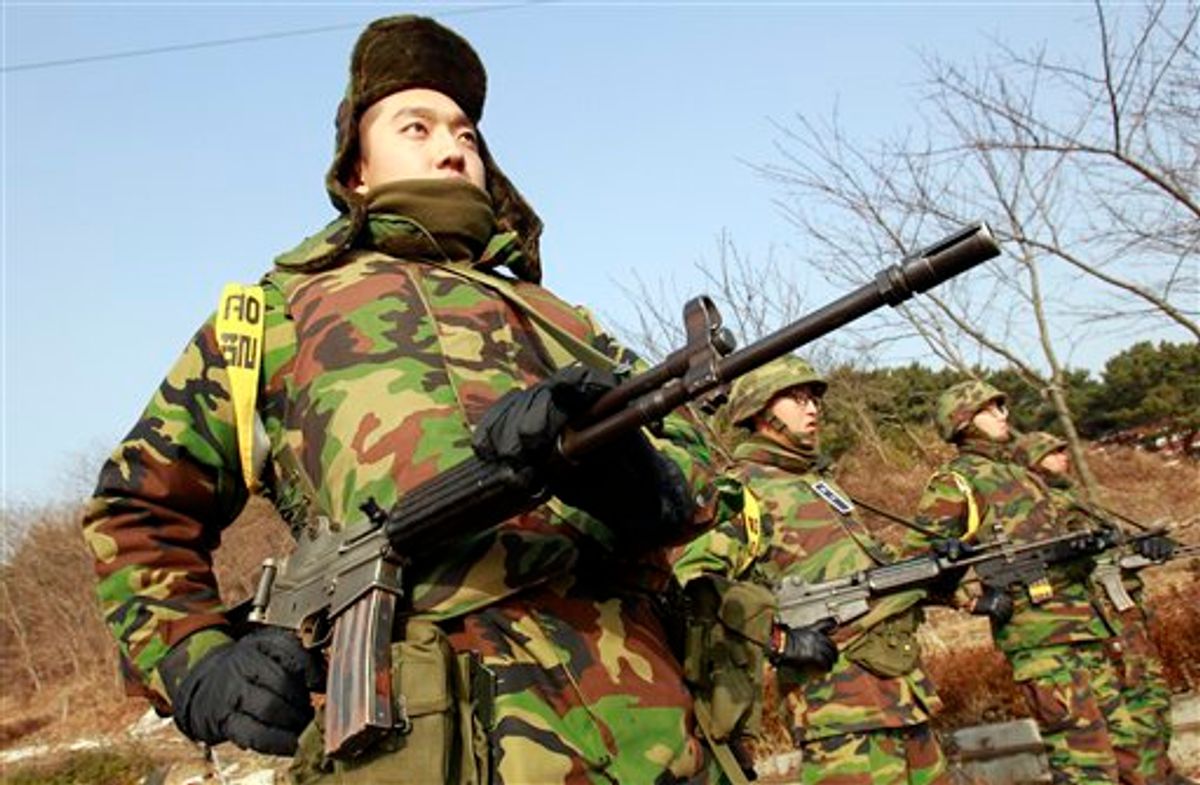 South Korean marines stand guard near the their military base on the Yeonpyeong Island, South Korea, Saturday, Nov. 27, 2010. Tensions have soared between the Koreas since the North's strike Tuesday destroyed large parts of Yeonpyeong in a major escalation of their sporadic skirmishes along the disputed sea border. (AP Photo/Lee Jin-man) (AP)
