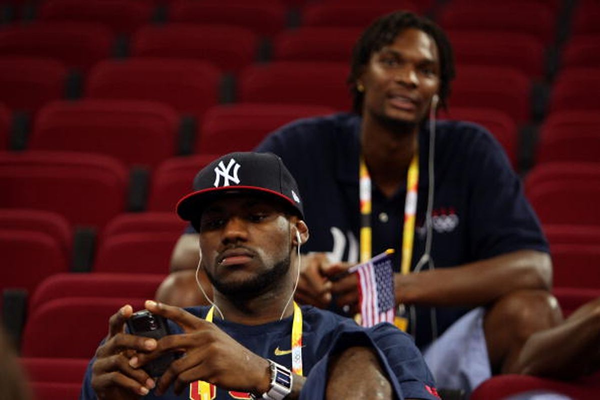 BEIJING - AUGUST 09:  (F-B) LeBron James and Chris Bosh of the United States men's basketball team sit in the stands for the US women's team game against the Czech Republic during the women's preliminary basketball game at the Beijing Olympic Basketball Gymnasium during day 1 of the Beijing 2008 Olympic Games on August 9, 2008 in Beijing, China.  (Photo by Mark Dadswell/Getty Images)  (Getty Images)