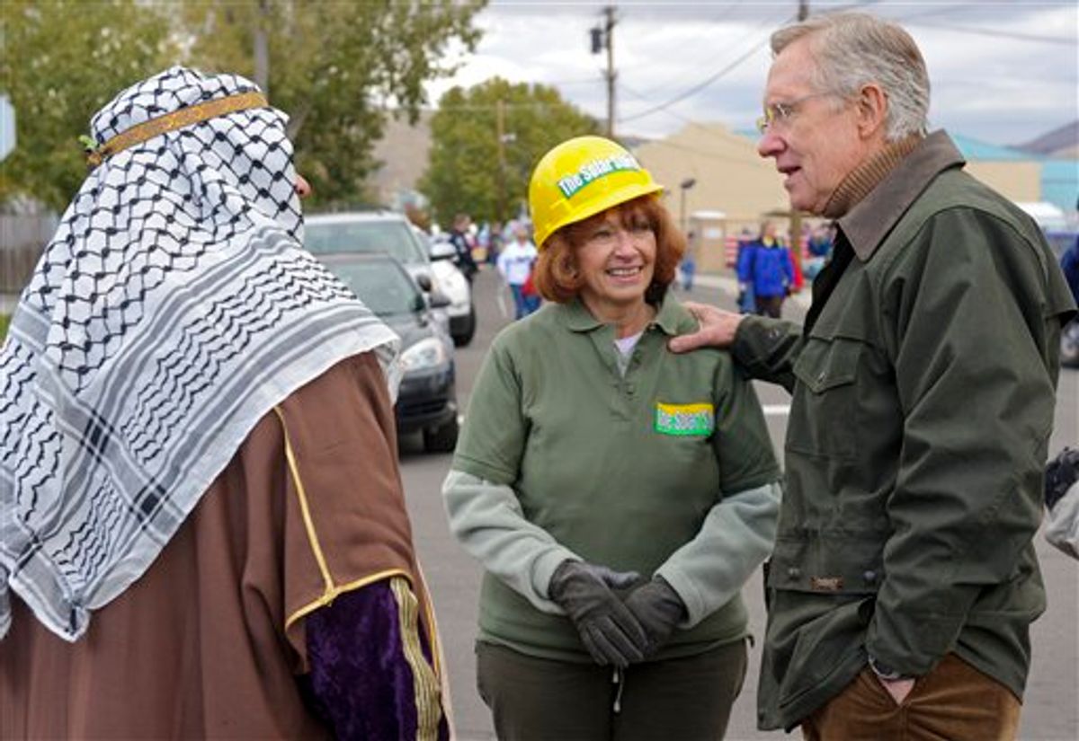 Nevada Sen. Harry Reid, D-Nev., talks with Leslie and James Medeiros, who are in costume to protest our dependence on foreign oil, during the Nevada Day Parade in Carson City, Nev., Saturday, Oct. 30, 2010. (AP Photo/Scott Sady) (AP)