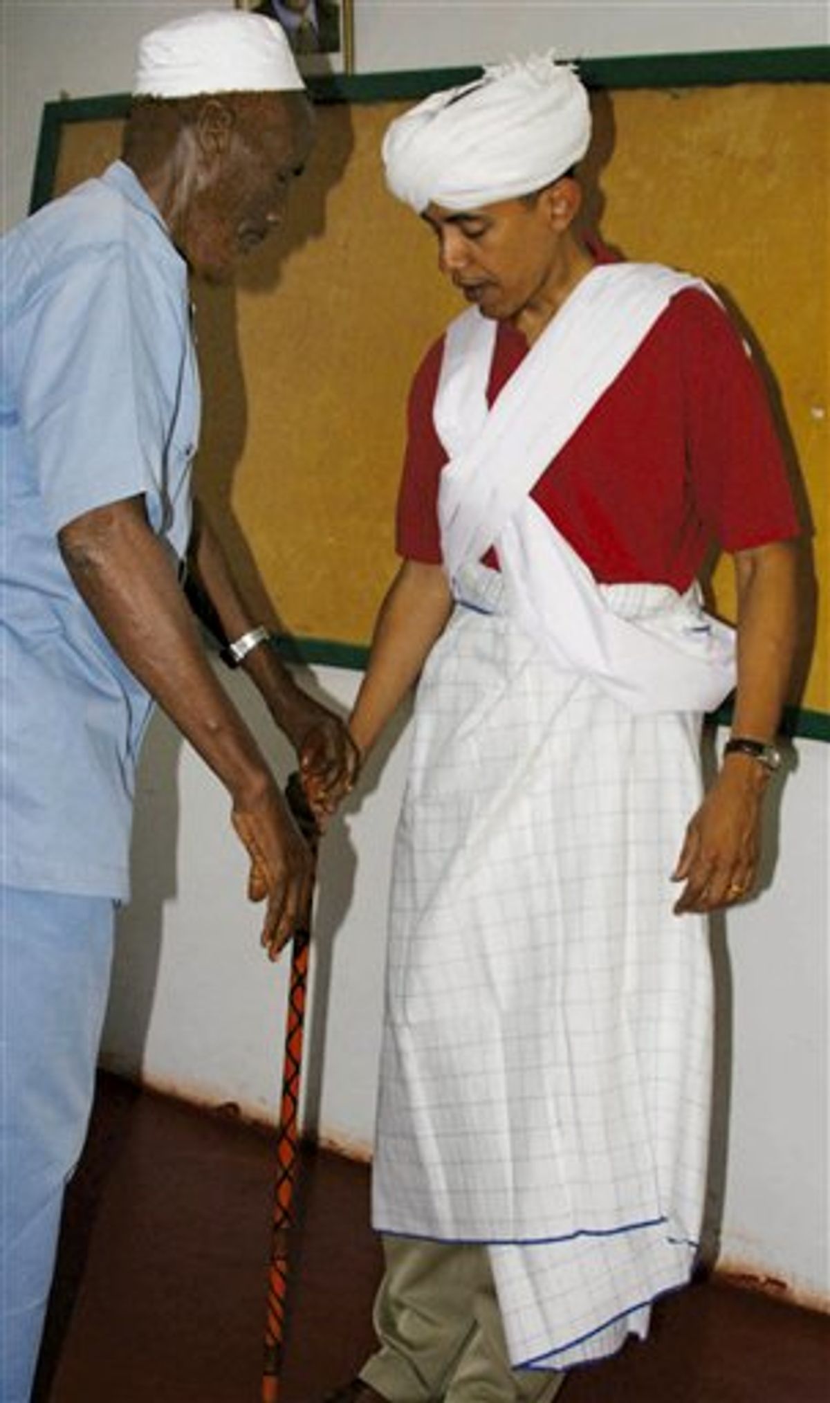 FILE  - In this 2006 file photo, then-Sen. Barack Obama, D-Ill., right, is dressed as a Somali Elder by Sheikh Mahmed Hassan, left, during his visit to Wajir, a rural area in northeastern Kenya, near the borders with Somalia and Ethiopia.  All presidents deal with image problems _ that they're too weak or too belligerent, too far left or far right. But Obama also faces questions over documented facts. Nearly one in five people, or 18 percent, said they think Obama is Muslim, up from the 11 percent who said so in March 2009, according to a poll released Thursday, Aug. 19, 2010. The proportion who correctly say he is a Christian is down to just 34 percent. (AP Photo, File) (AP)