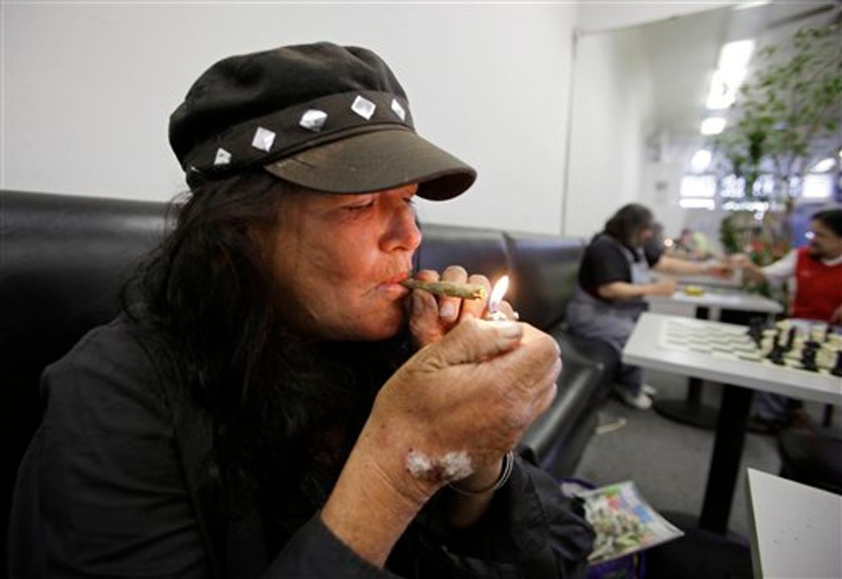 Susan Recht smokes a marijuana cigarette at the San Francisco Medical Cannabis Clinic in San Francisco, in this photo taken Oct. 15, 2010. In a campaign season brimming with partisan rancor, leading Democrats and Republicans in a few states have found common cause in opposing ballot measures they say would wreak havoc by legalizing marijuana and slashing tax revenue. (AP Photo/Eric Risberg) (AP)