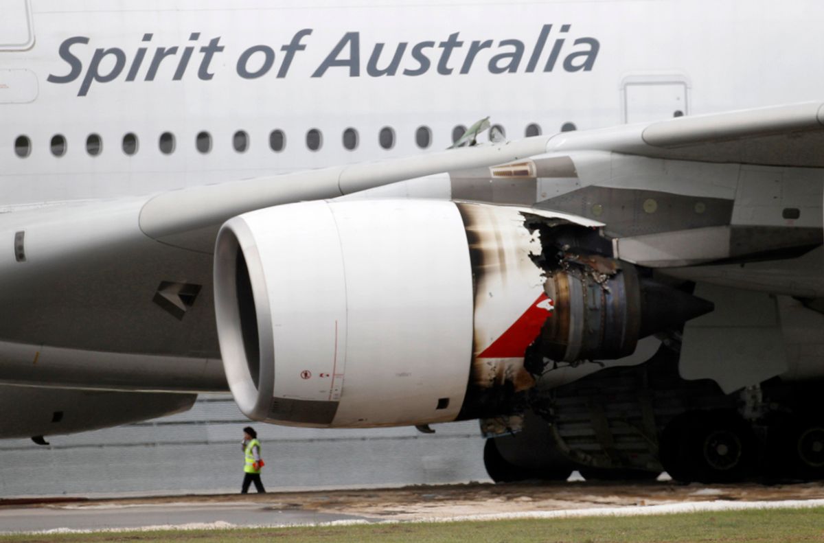 Qantas Airways A-380 passenger plane QF32 with its partially damaged engine sits on the tarmac after making an emergency landing at Changi airport in Singapore November 4, 2010. The Qantas Airways passenger plane carrying 459 people was forced to shut down an engine and return to to Singapore's Changi airport on Thursday, ending speculation that it had crashed, the airline and Singapore state TV said.   REUTERS/Vivek Prakash   (SINGAPORE - Tags: TRANSPORT DISASTER BUSINESS) (Â© Vivek Prakash / Reuters)