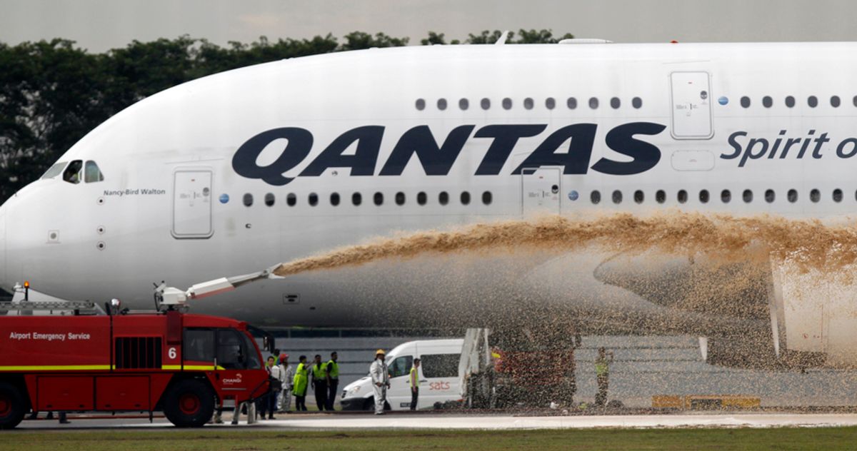 Qantas Airways 380 passenger plane flight QF32 is sprayed by rescue services after making an emergency landing at Changi airport in Singapore November 4, 2010. The Airbus A380, which had originated in London and was carrying 459 people, suffered failure of one of its four engines shortly after it had left the island state en route for Sydney. Australian officials said no one on board was injured.    REUTERS/Vivek Prakash   (SINGAPORE - Tags: TRANSPORT DISASTER BUSINESS IMAGES OF THE DAY) (Â© Vivek Prakash / Reuters)