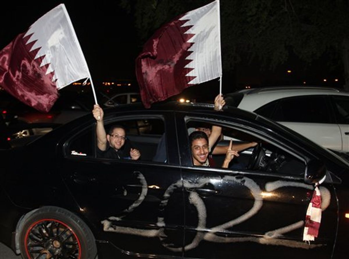 Qataris react in a car, after the announcement that Qatar will host the soccer World Cup in 2022, in Doha, Thursday, Dec. 2, 2010. (AP Photo/Osama Faisal) (AP)