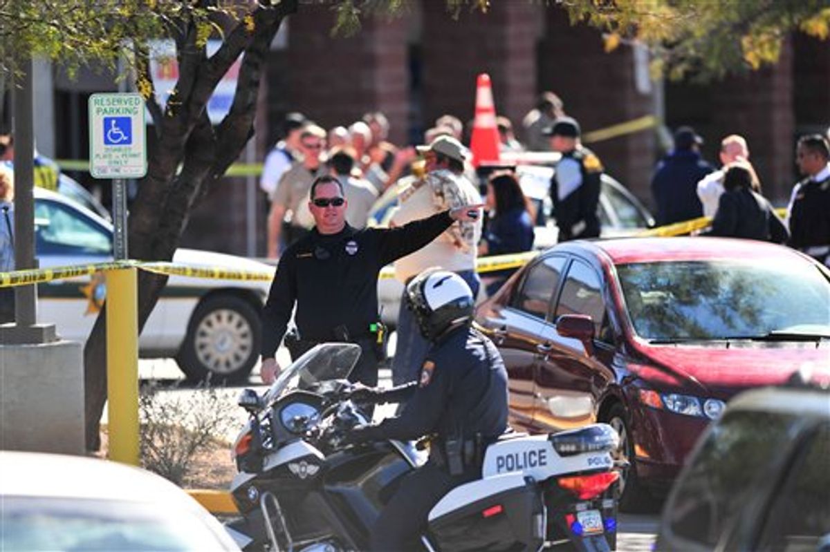 Emergency workers gather at the scene of a shooting involving Rep. Gabrielle Giffords, D-Ariz., Saturday, Jan. 8, 2011, at a Safeway grocery store in Tucson, Ariz.  (AP Photo/Chris Morrison) (AP)