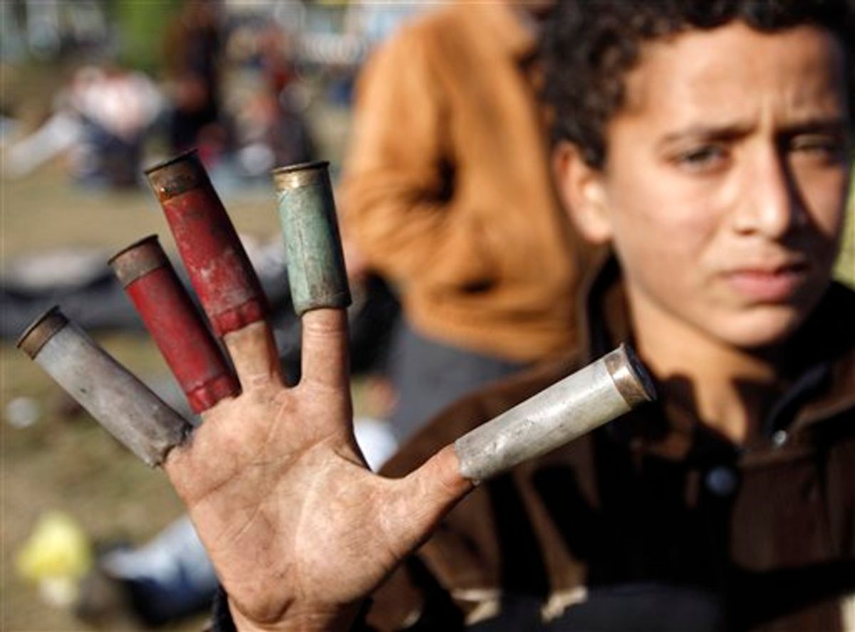 A boy shows spent cartridges used by Egyptian security forces, in Cairo, Sunday, Jan. 30, 2011. The Arab world's most populous nation appeared to be swiftly moving closer to a point at which it either dissolves into widespread chaos or the military expands its presence and control of the streets. (AP Photo/Tara Todra Whitehill) (AP)