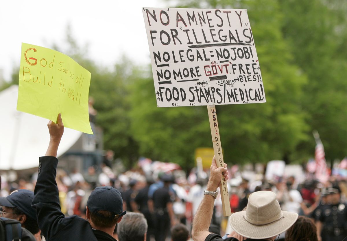 Anti-immigration demonstrators hold signs at an immigration rally in Dallas on Saturday, May 1, 2010. Large crowds were expected in Dallas after a new Arizona law passed requiring authorities to question people about their immigration status if they are suspected of being in the country illegally. (AP Photo/Mike Fuentes) (Associated Press)