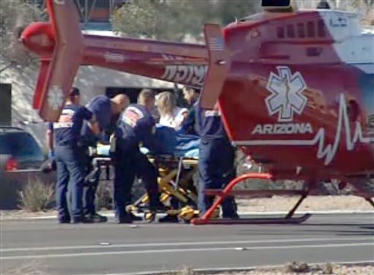 Emergency personnel use a stretcher to carry a shooting victim to a helicopter outside a shopping center in Tucson, Ariz. on Saturday, Jan. 8, 2011 where U.S. Rep. Gabrielle Giffords, D-Ariz., and others were shot as the congresswoman was meeting with constituents. (AP Photo/KGUN9-TV) MANDATORY CREDIT KGUN9-TV (AP)