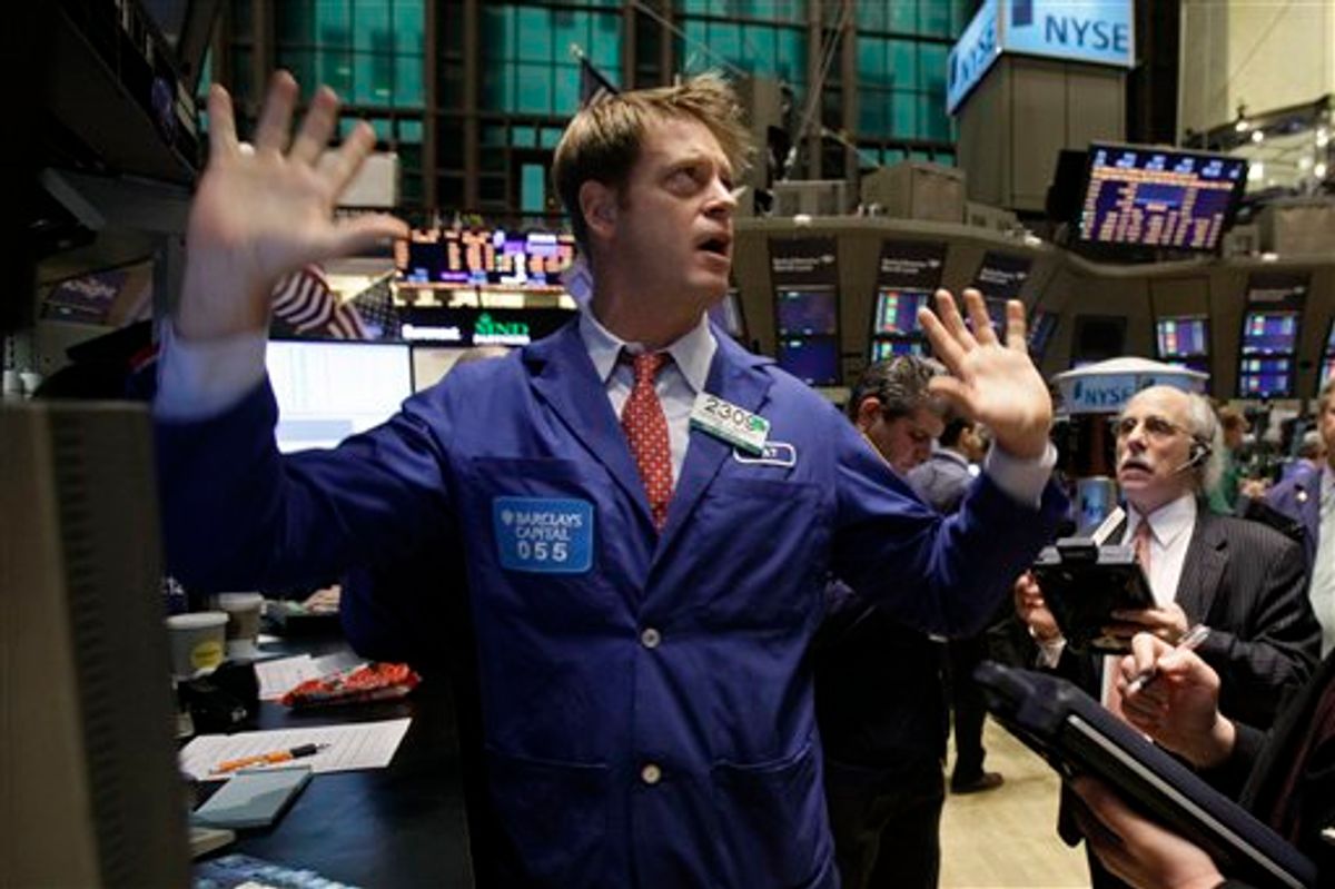 Specialist Patrick Murphy, left, works at his post on the floor of the New York Stock Exchange Tuesday, Jan. 25, 2011. (AP Photo/Richard Drew) (AP)