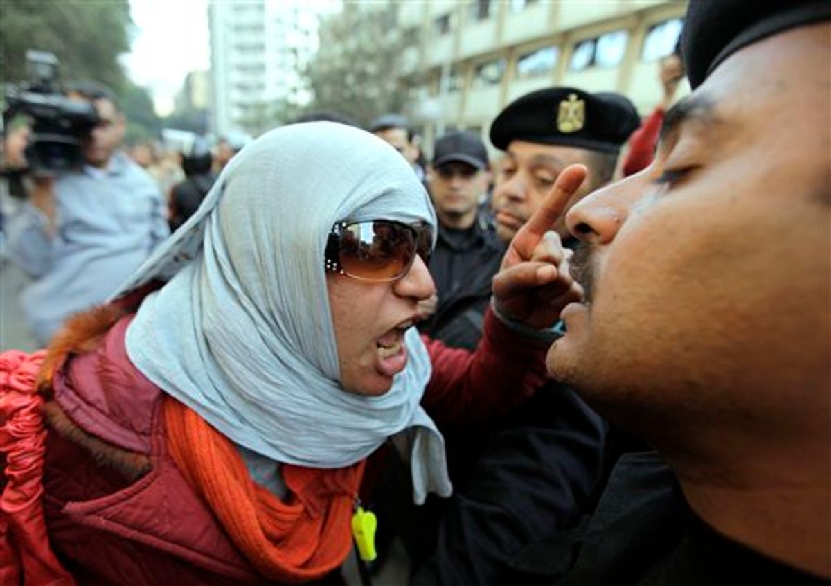 Angery Egyptian activist shouts at anti-riot policemen who block the way leading to journalists syndicate in downtown Cairo, Egypt, Wednesday, Jan. 26, 2011. A small gathering of Egyptian anti-government activists tried to stage a second day of protests in Cairo Wednesday in defiance of a ban on any gatherings, but police quickly moved in and used force to disperse the group. (AP Photo/Ben Curtis) (AP)