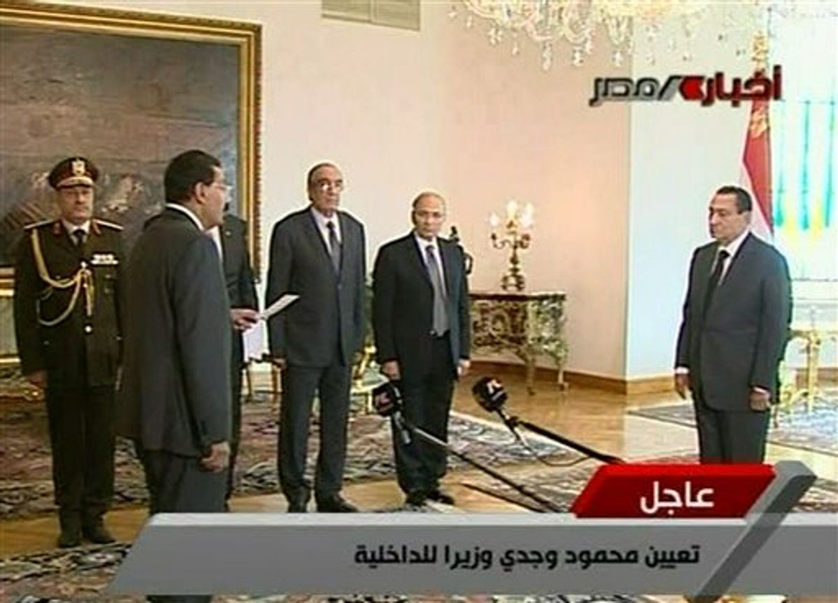 In this image taken from Egypt State TV, showing Egyptian President Hosni Mubarak, right, as he swears in General Mahmoud Wagdy as the new interior minister, front left, during a ceremony to swear in the new government Cabinet as broadcast on Egypt State TV, Monday Jan. 31, 2011.  State TV has announced that Egyptian President Hosni Mubarak has sworn in a new Cabinet, replacing the Cabinet which was dissolved as a concession to unprecedented anti-government protests.( AP Photo / Egypt State TV) MANDATORY CREDIT -  TV OUT - EGYPT OUT (AP)