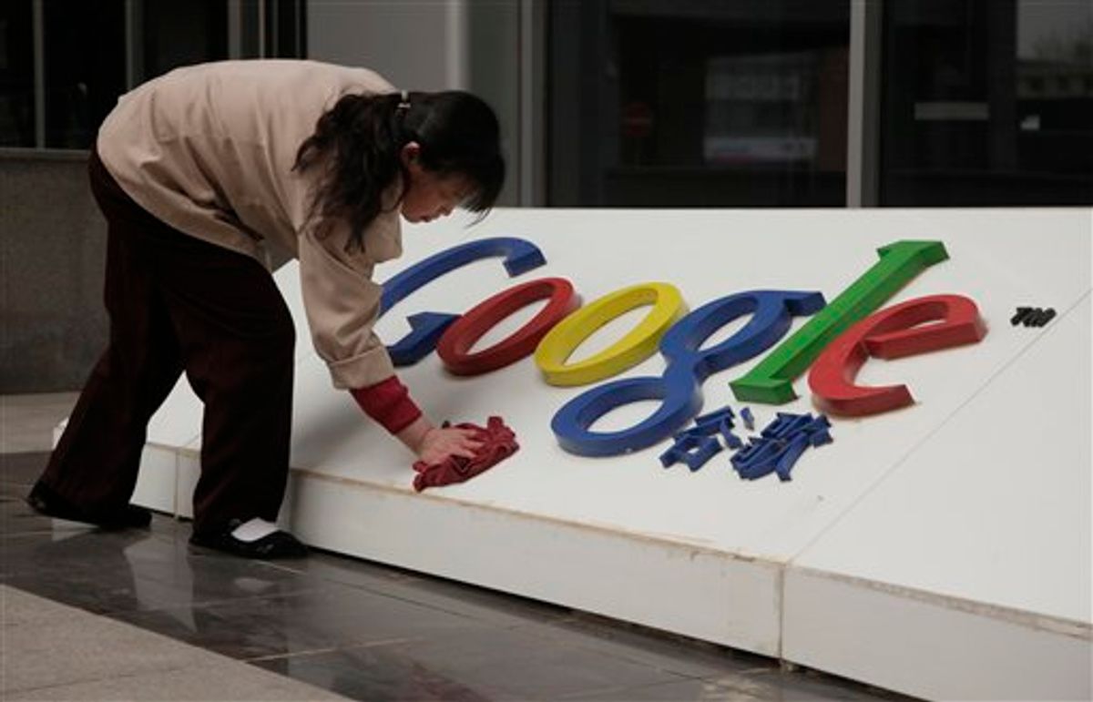 In this photo taken Monday, March 22, 2010, a Chinese woman cleans the Google logo outside the Google China headquarters in Beijing, China.  A leaked U.S. government cable shows sources told American diplomats that hacking attacks against Google were ordered by China's top ruling body.  (AP Photo/Ng Han Guan) (AP)