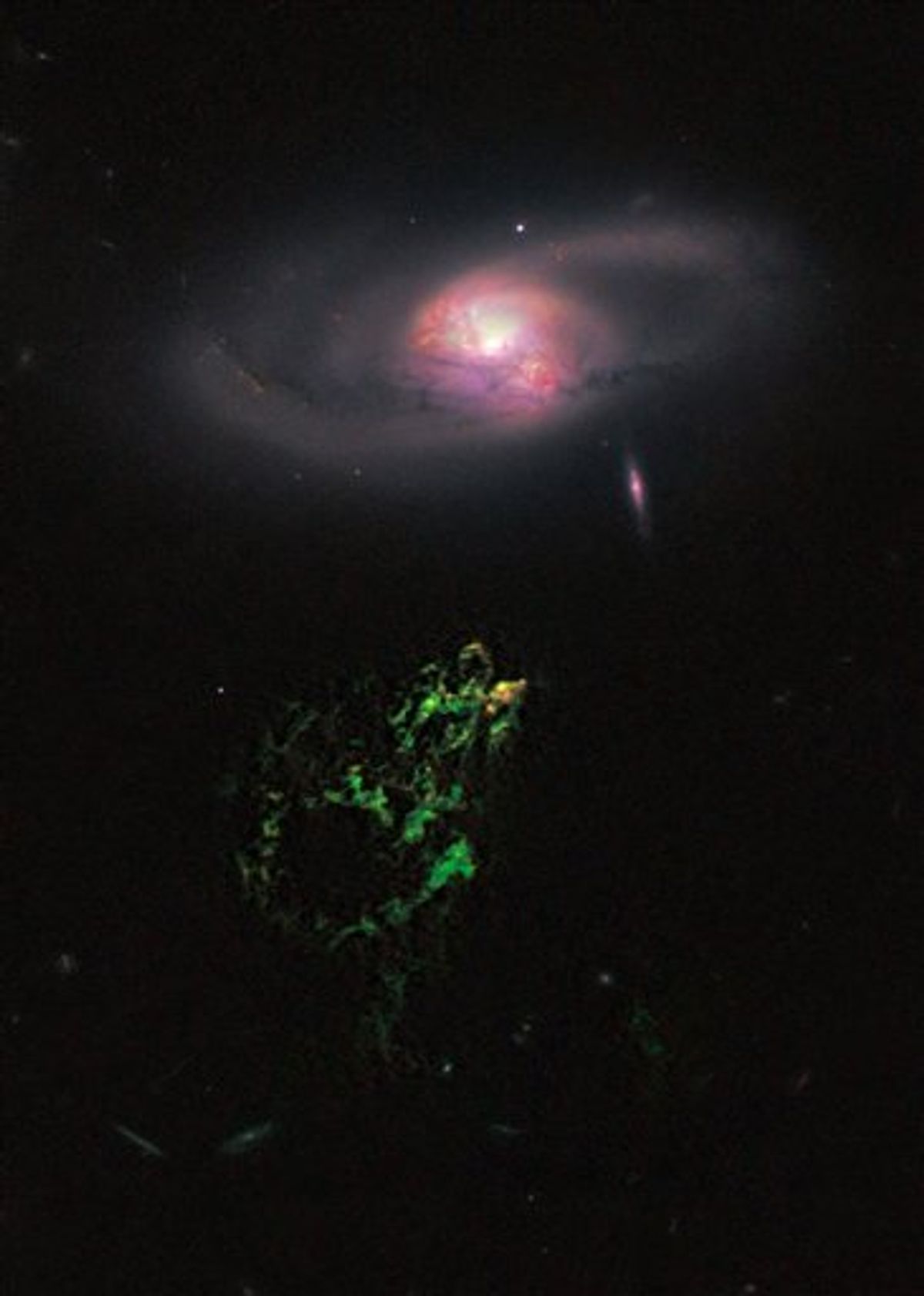 This handout photo provided by NASA, taken April 12, 2010 by the Hubble Space Telescope, shows an unusual, ghostly green blob of gas appears to float near a normal-looking spiral galaxy. NASA released Monday the Hubble Space Telescopes first picture of the mysterious giant glowing green blob of gas called Hannys Voorwerp.  The blob is the size of our Milky Way galaxy and is 650 million light years away. Each light year is about 6 trillion miles. The blob was discovered in 2007 by Dutch school teacher Hanny van Arkel. (AP Photo/Hubble Space Telescope Science Institute)  (AP)