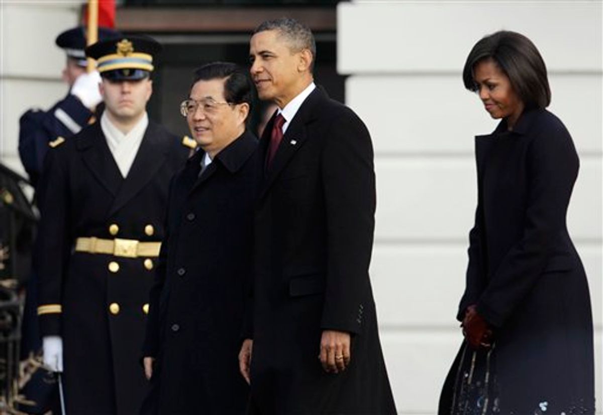 President Barack Obama and first lady Michelle Obama welcome China's President Hu Jintao during a state arrival on the South Lawn of the White House in Washington, Wednesday, Jan. 19, 2011. (AP Photo/Charles Dharapak)  (AP)